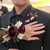 Boutonniere and wrist corsage with burgundy and white flowers