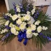 large basket with spray of blue and white flowers.