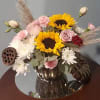 Petal pinks and burgendy, roses, sunflowers and some uncomon pairings make for