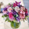Pink and purple rose bouquet in a clear glass vase