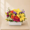 Colorful flower arrangement in a white rectangular box