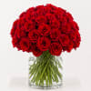 Large bouquet of red roses in a clear glass vase