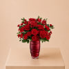 A bold and passionate arrangement of red roses, carnations, and alstroemeria in