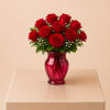 A stunning flower arrangement featuring fresh red roses, beautifully designed in a