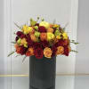 Mixed roses in a black cylindrical vase
