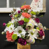 Mixed bouquet in a candle jar with a "Love you Mom" card