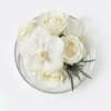 White floral bouquet in a clear round container