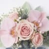 Soft pink roses and orchids arranged in a bridal bouquet