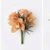Peach orchid bouquet with dark accent foliage on a white background