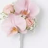 Small pink orchid and rose boutonniere on a white background