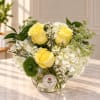 Yellow roses and white hydrangeas in a clear glass vase