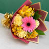 Pink gerbera bouquet with yellow and cream flowers in burgundy wrap