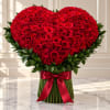 Heart-shaped bouquet of red roses with a red ribbon