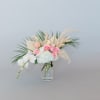 Pink roses and white orchids in a clear glass vase