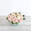 Low bouquet of pale pink and white roses in a clear glass bowl