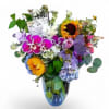 Mixed bouquet with orchids, sunflowers, hydrangeas, and a glass vase