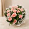 Bouquet of pale pink roses with white filler flowers and greenery