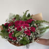 Bouquet of hot pink roses with white filler flowers and greenery