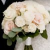 Bouquet of pale pink and white roses with eucalyptus greenery