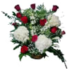 Basket arrangement of red roses and white hydrangeas