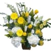 Yellow and white mixed flower arrangement in a woven basket