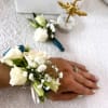 White rose wrist corsage with baby's breath and ribbon