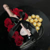 Heart-shaped gift box with red roses, champagne, and gold-wrapped chocolates
