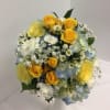 Bouquet of yellow roses, blue hydrangeas, and white filler flowers