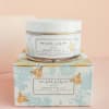 Jar of body butter on a decorative box
