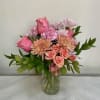Soft, garden-fresh colors and a relaxed round shape make this flower arrangement