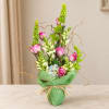 Pink roses and snapdragons in a green wrapped vase arrangement