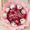 Pink-wrapped bouquet of roses and white daisies
