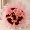 Bouquet of red and pink roses with three pink gerbera daisies