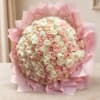 Large bouquet of pale pink and white roses wrapped in pink paper