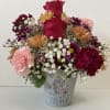 Arrangement includes roses, lilies, carnations,  daisy, filler and assorted greenery