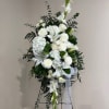 Tall white floral standing spray with lilies and mums on an easel