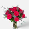 Bouquet of bright pink roses in a clear glass vase
