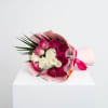 Bouquet of pink and white roses wrapped in pink paper