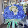 Blue hydrangea bouquet with white alstroemeria and a sheer ribbon handle