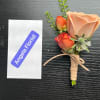 Small boutonniere with peach and orange roses tied with twine