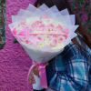 Pink and white rose bouquet with a birthday ribbon