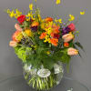 Colorful mixed bouquet in a round glass vase
