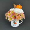 Mug arrangement of peach and white chrysanthemums with a pumpkin topper