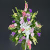 A mixed floral standing spray of Pastel colored flowers - Customizable to