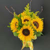 Sunflower bouquet in a glass vase with yellow ribbon