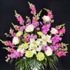 Pink and white floral arrangement with lilies, roses, and snapdragons