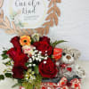 Red roses with a teddy bear and chocolates in a gift box