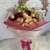 Bouquet of peach and red roses with gold chocolates and a butterfly topper