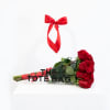 Bouquet of red roses in a clear tote bag with a red ribbon