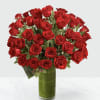 Bouquet of red roses in a tall glass vase